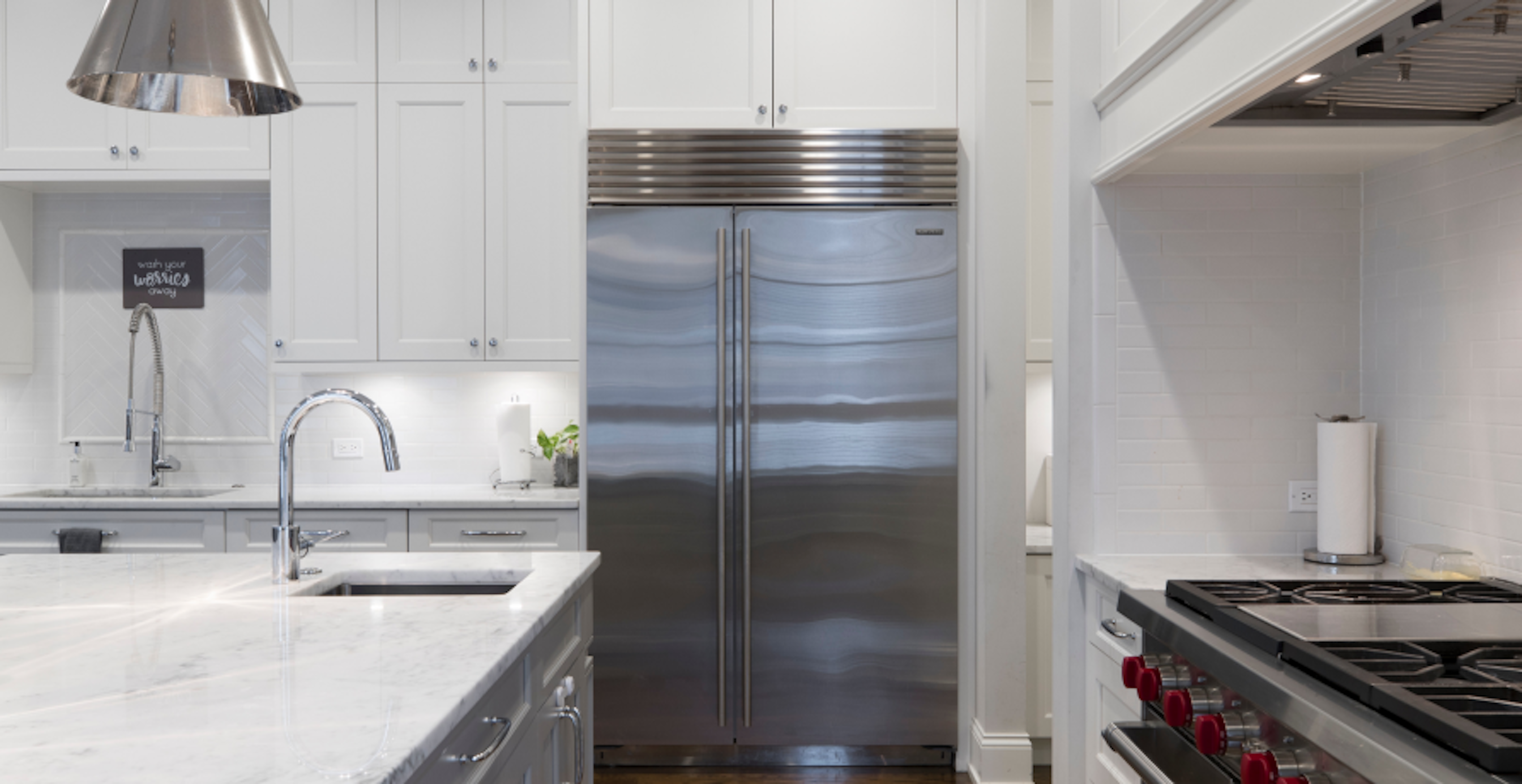 modern white and steel kitchen with view of fridge