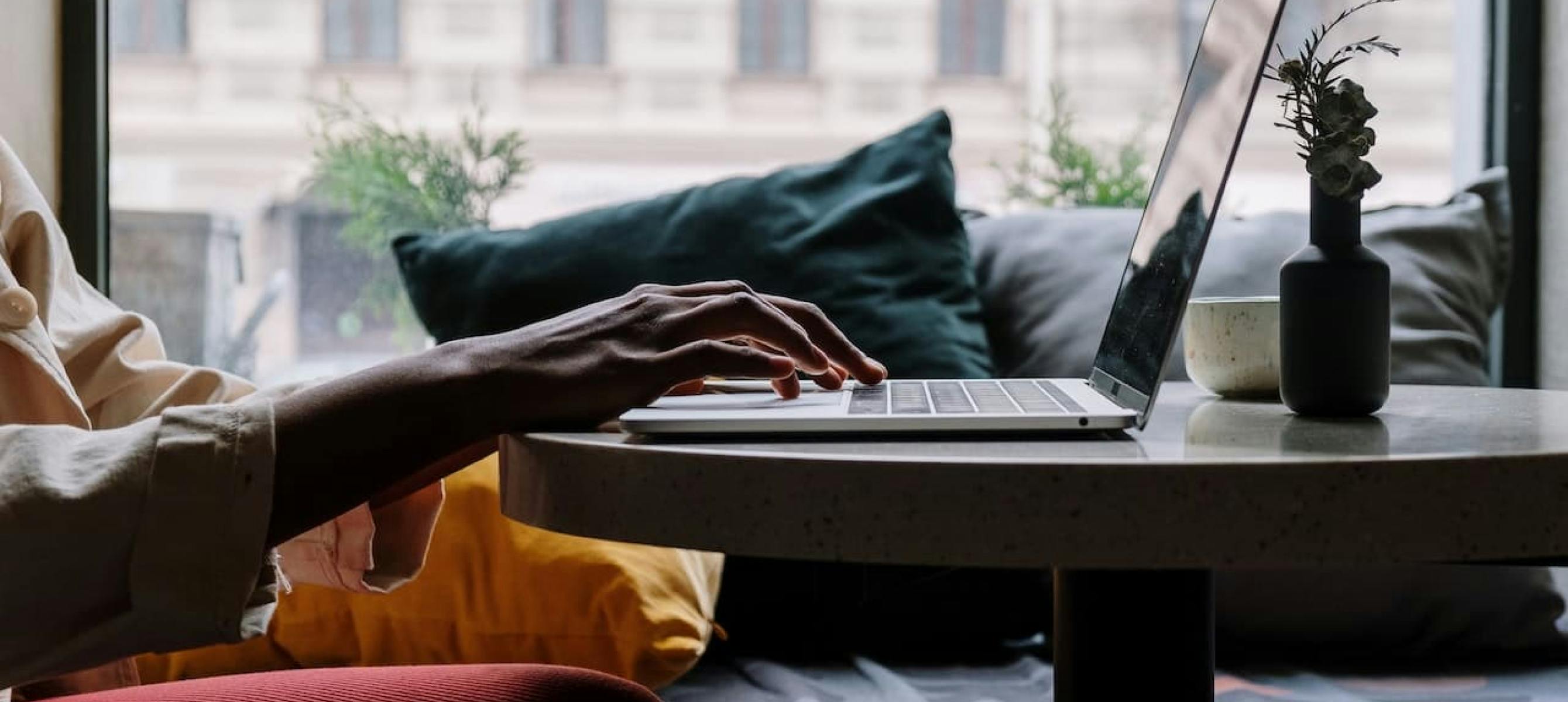 A person sitting in front of a laptop