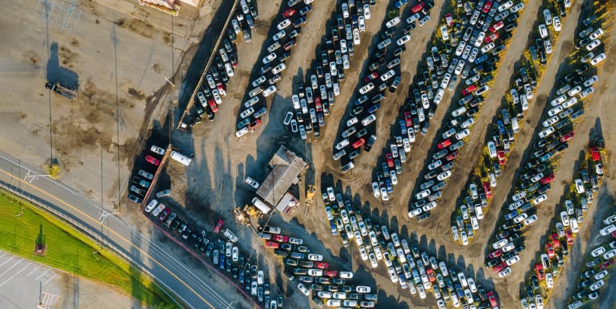 cars in giant parking lot birds eye view