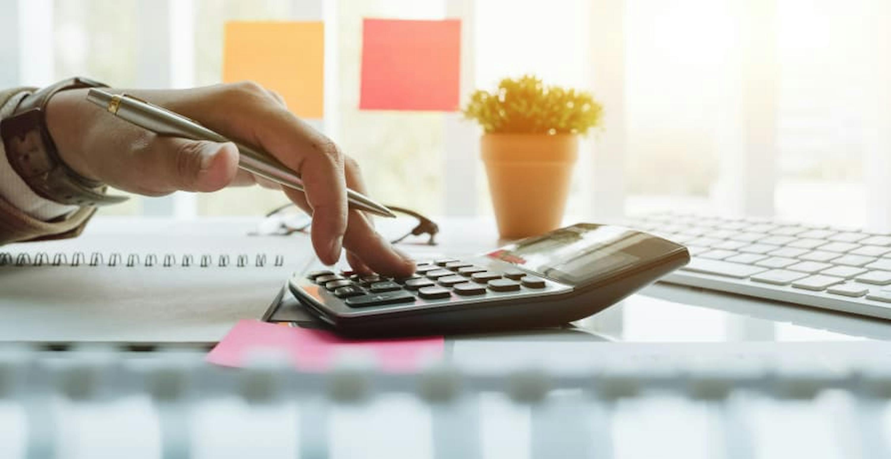 person using calculator in the sunlight