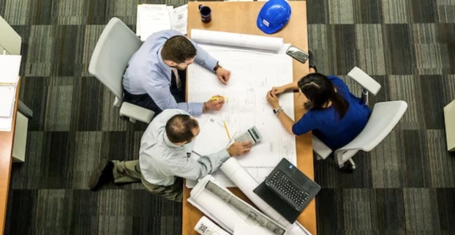 people sitting at a tabke working out business plan bird's eye view