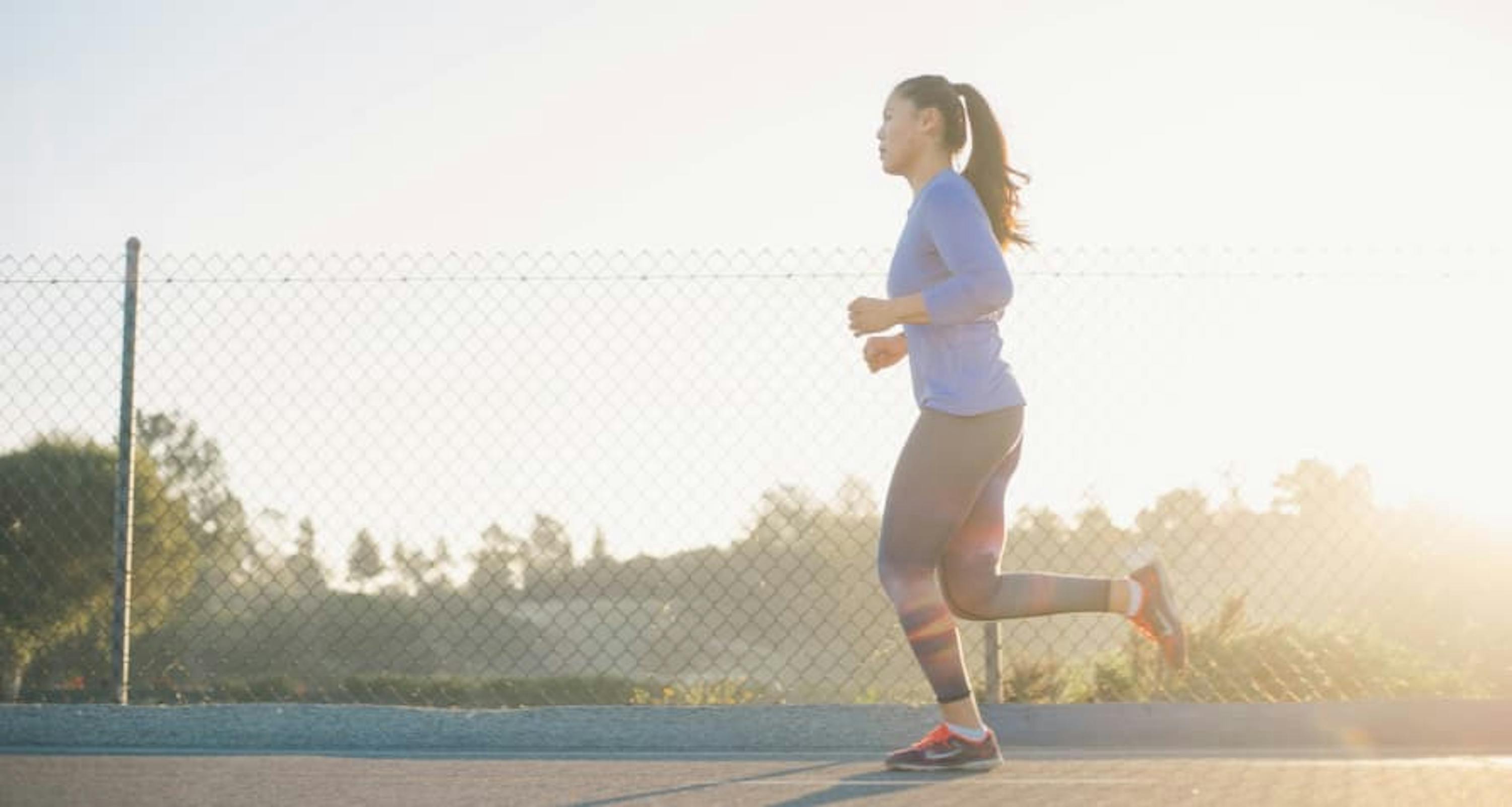 person running with sunshine