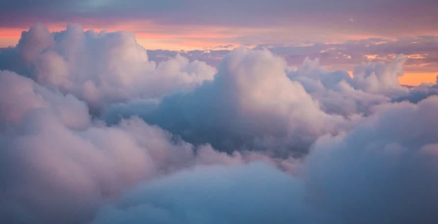 puffy clouds in sunset