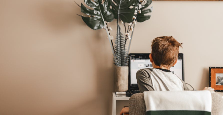 boy sitting at computer desk