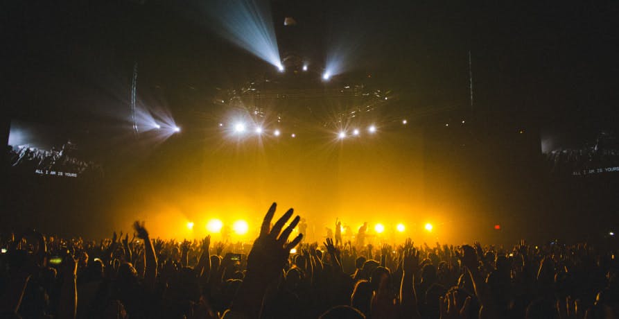 indoor concert golden lights from crowd