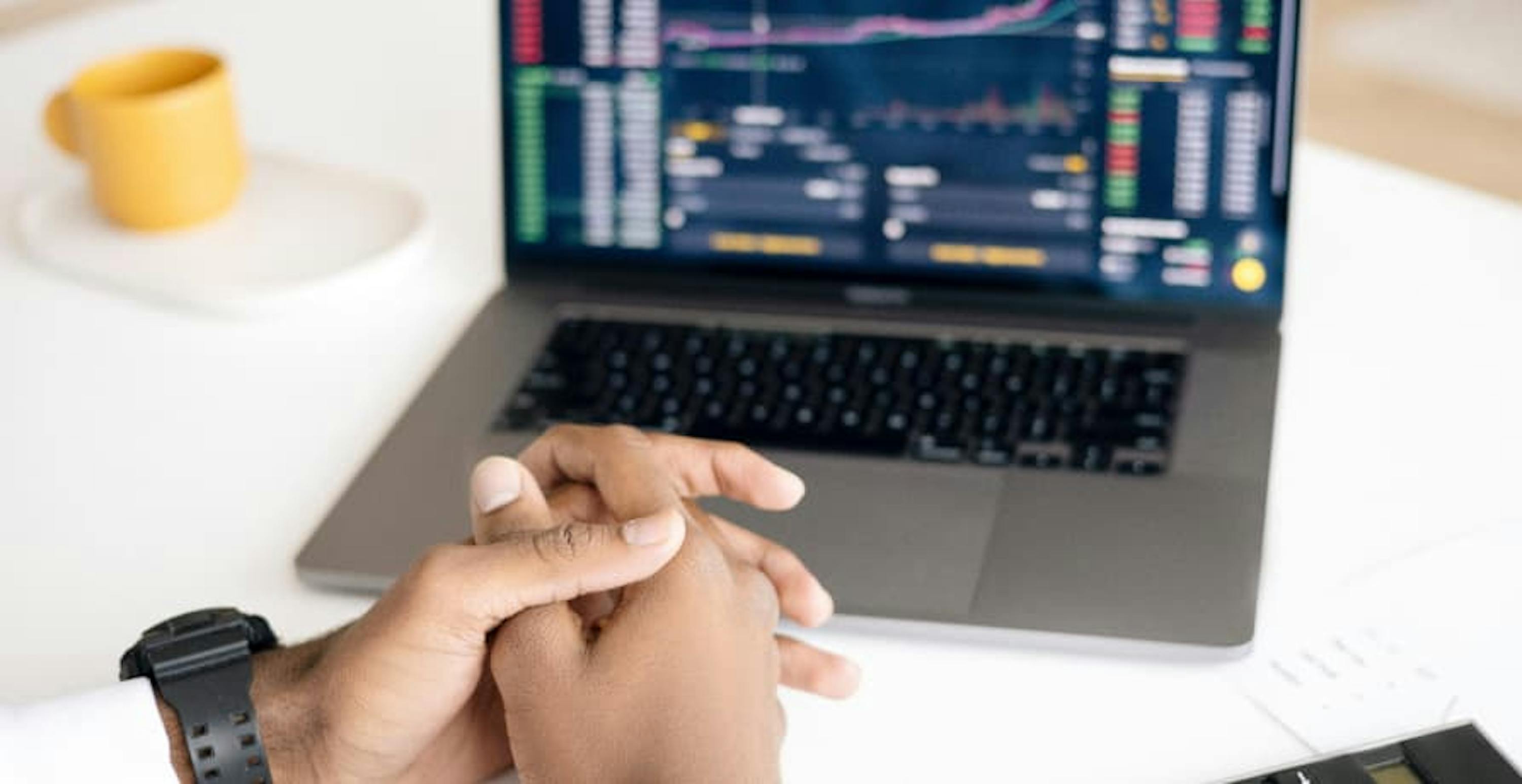 man looking at investment data on laptop