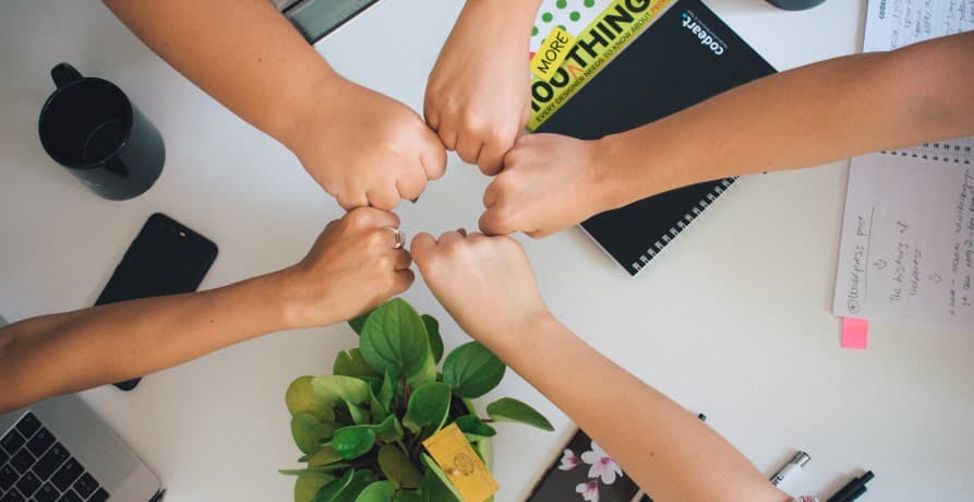 teamwork fists together