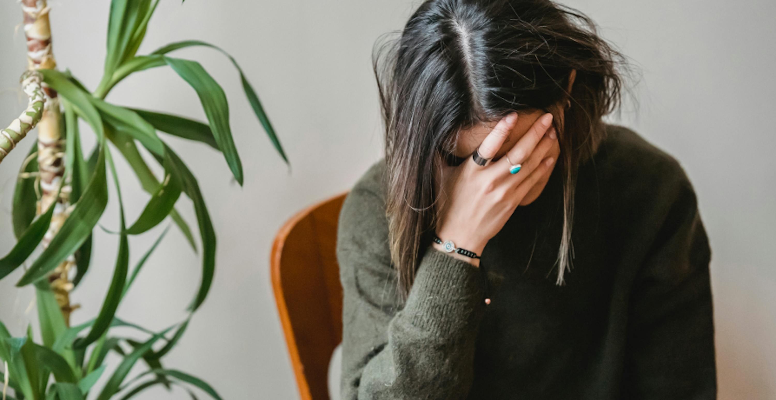 anxious woman with her head in her hands