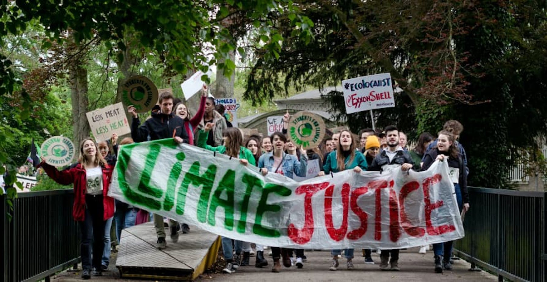 climate protesters holding a climate justice sign