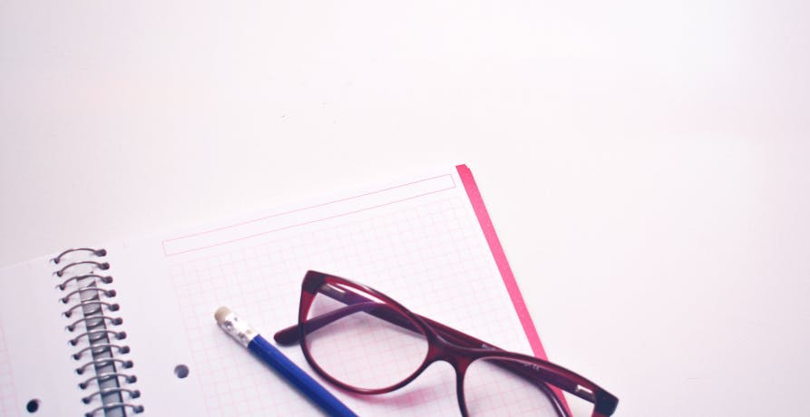 glasses pencil and notebook
