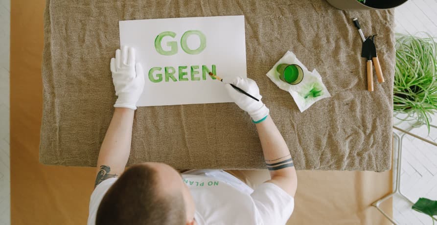 person painting go green sign