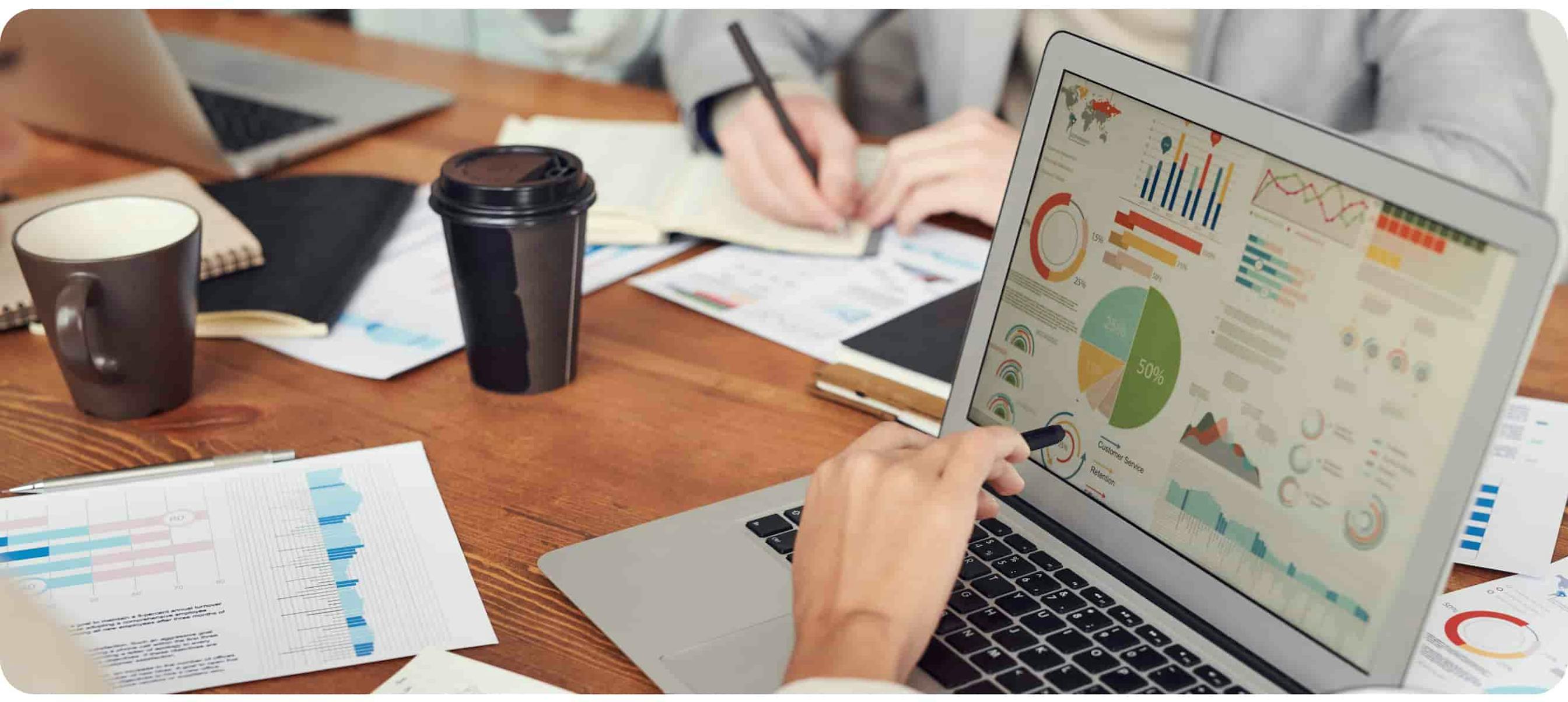 Photo of person pointing on laptop