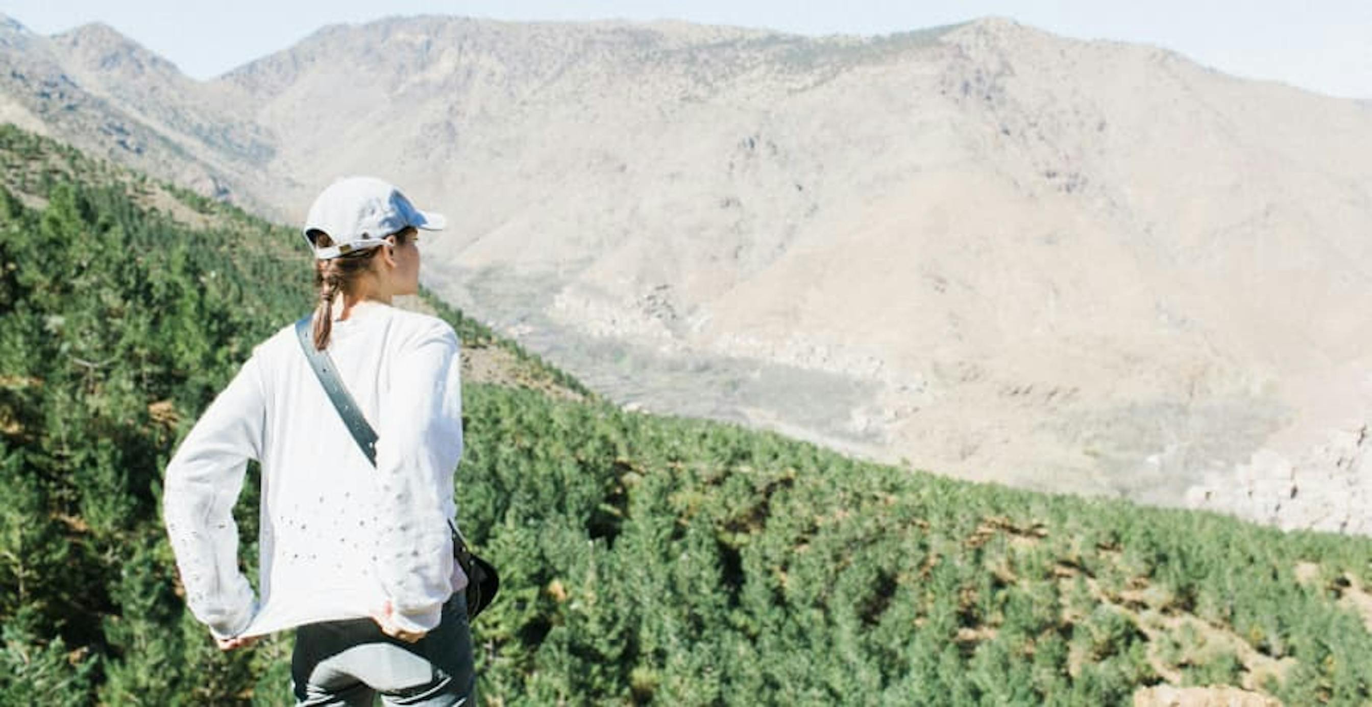 woman looking out over a forest