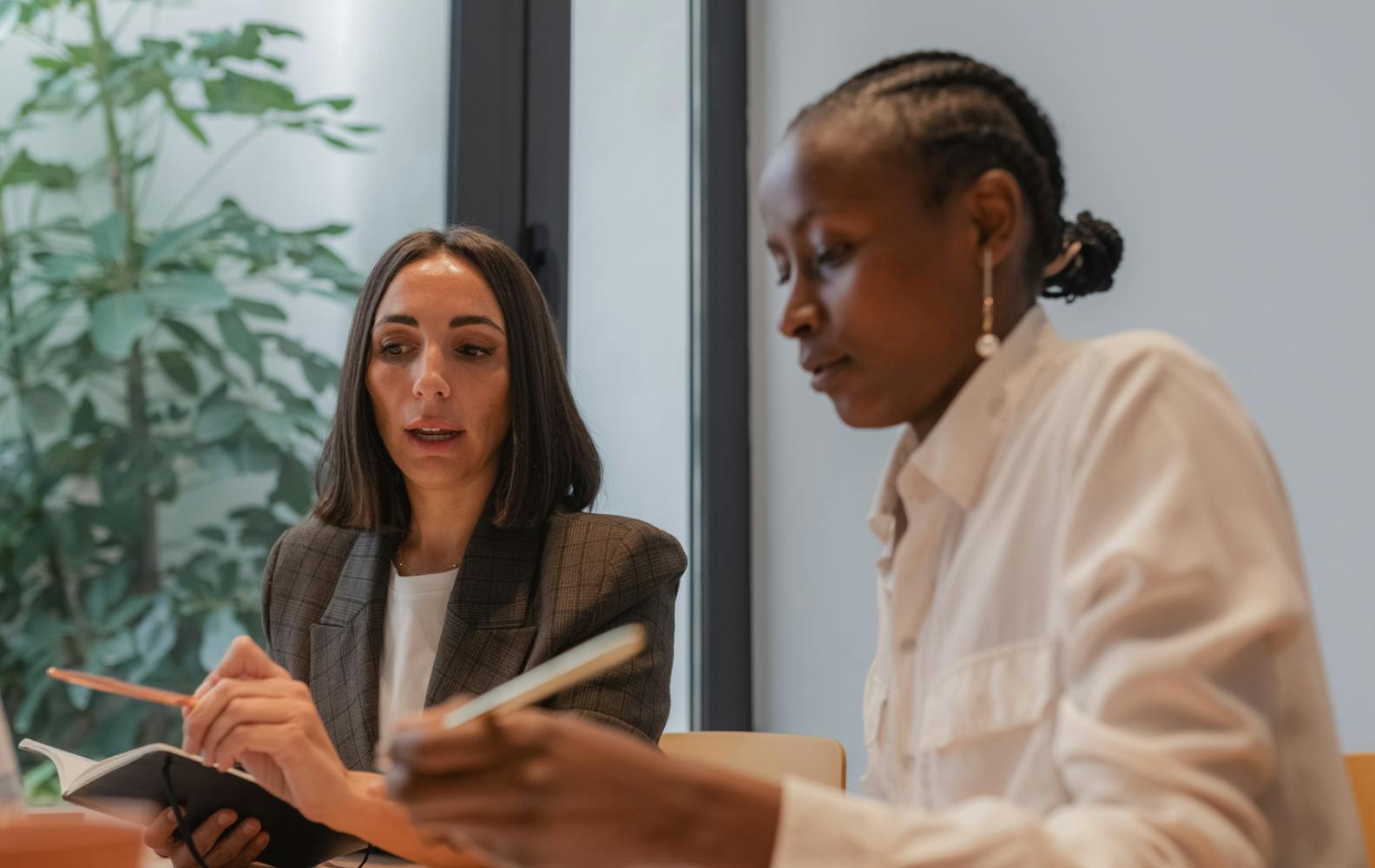 women in meeting discussing ESG performance for companies