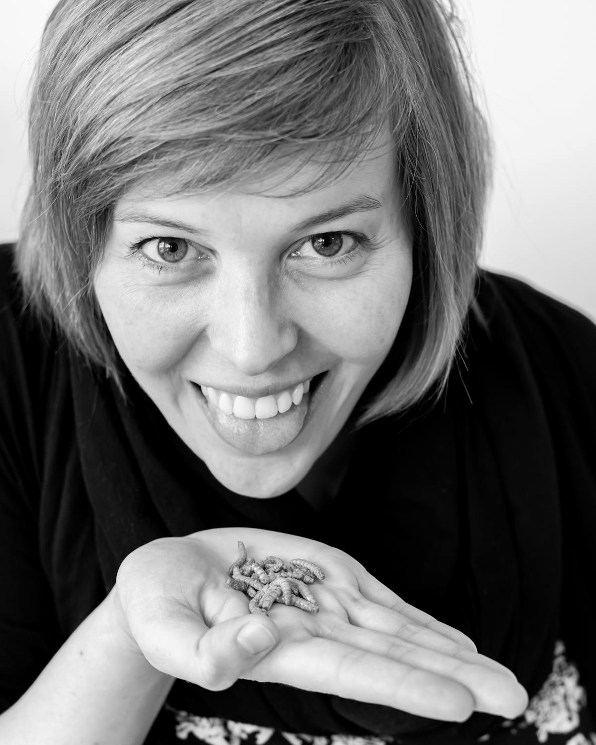 Woman holding edible insects on her hand