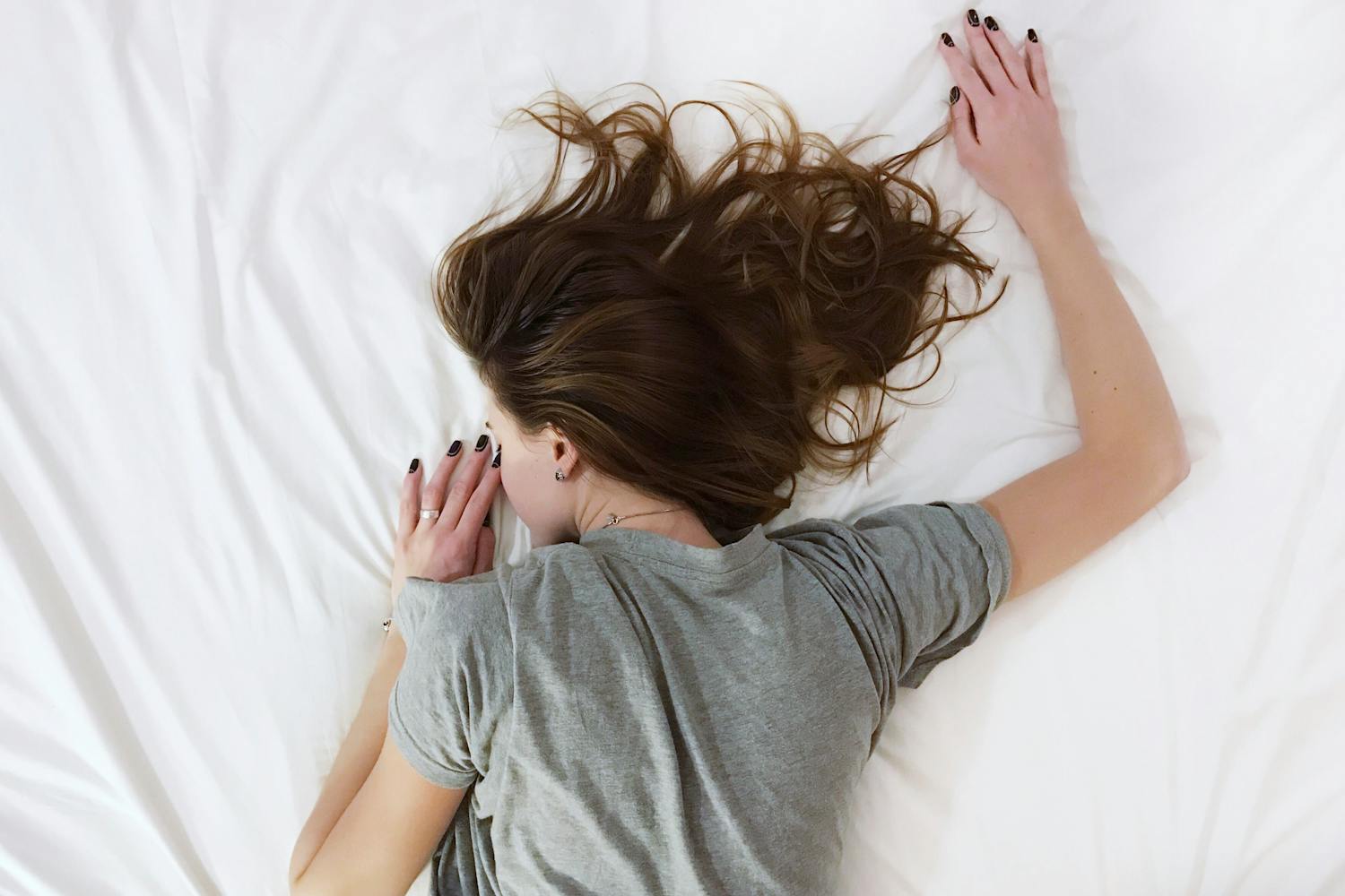 Tired girl lying in bed