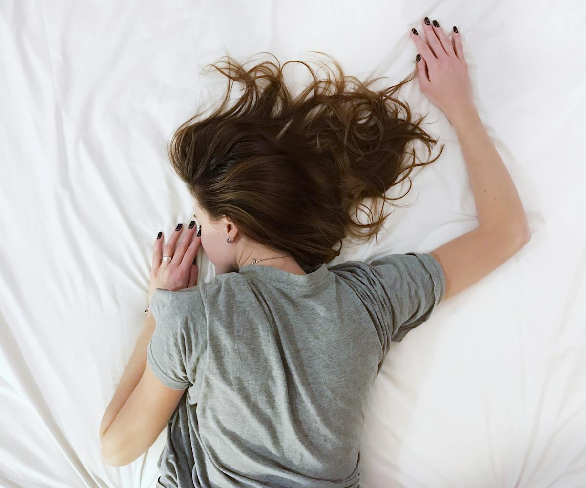 Tired girl lying in bed