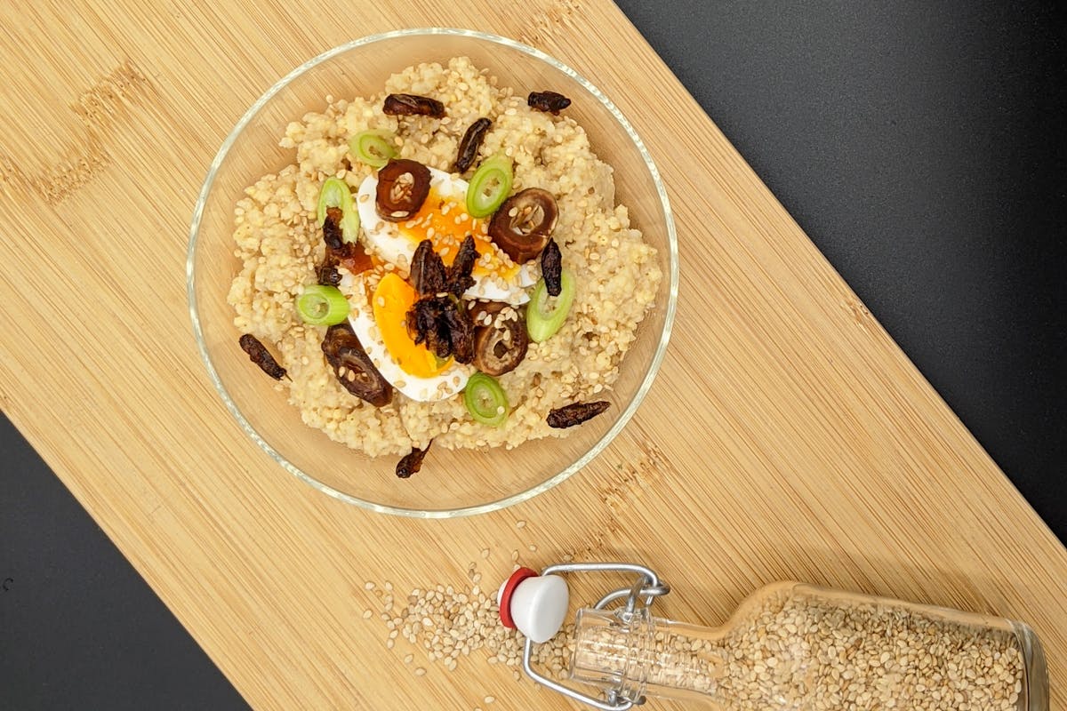 A bowl of cricket millet with some sesame on the side