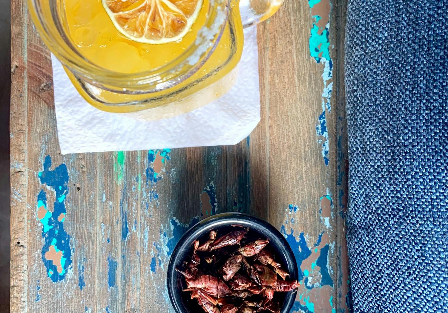 Crickets in a bowl and a jar of lemonade