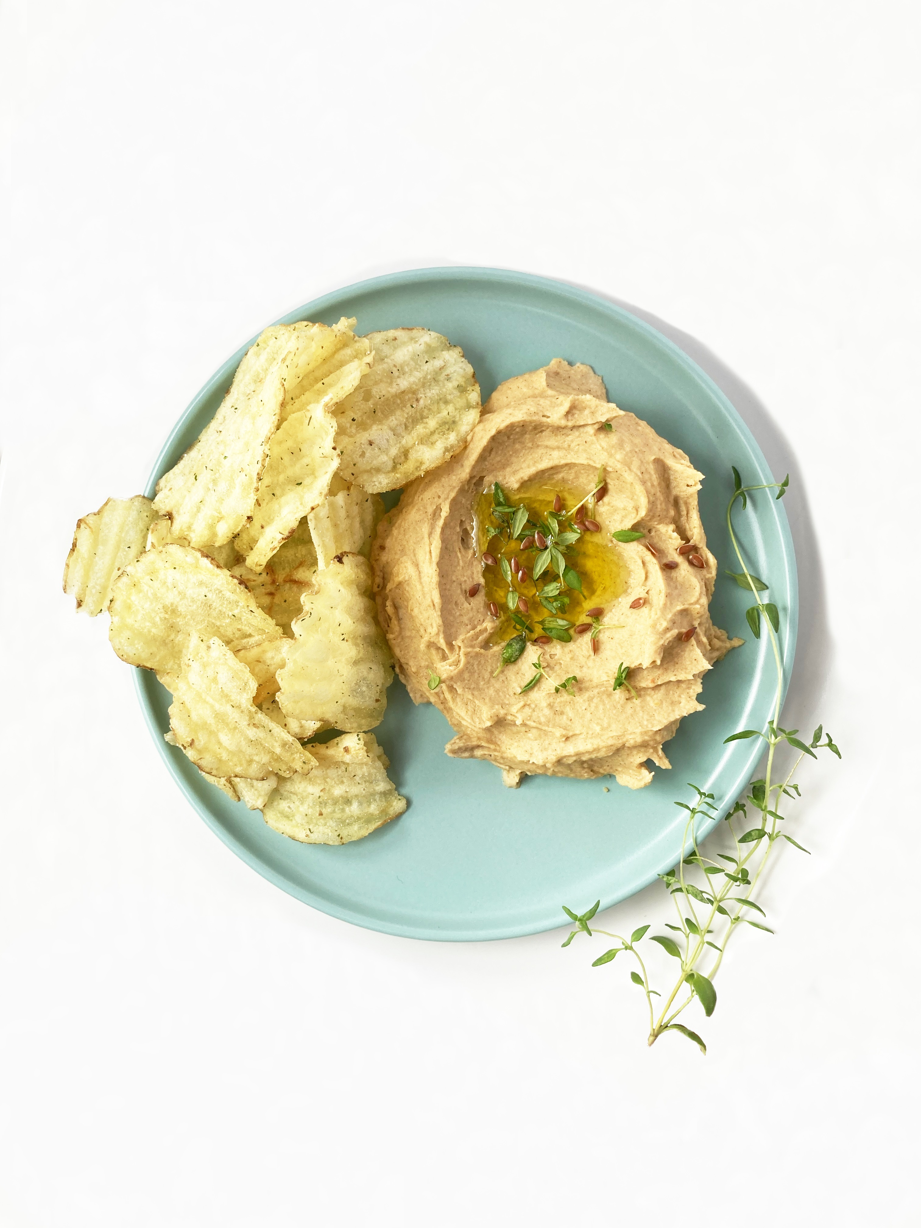 Hummus and crisps on a plate