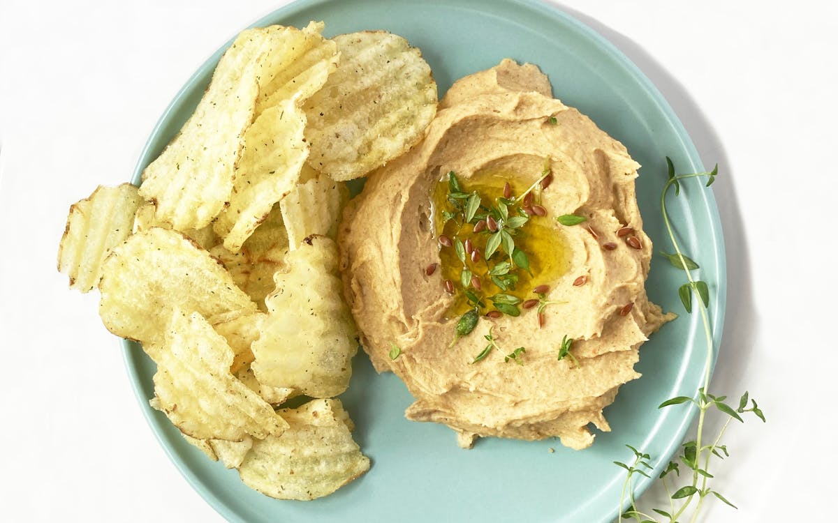 Hummus and crisps on a plate