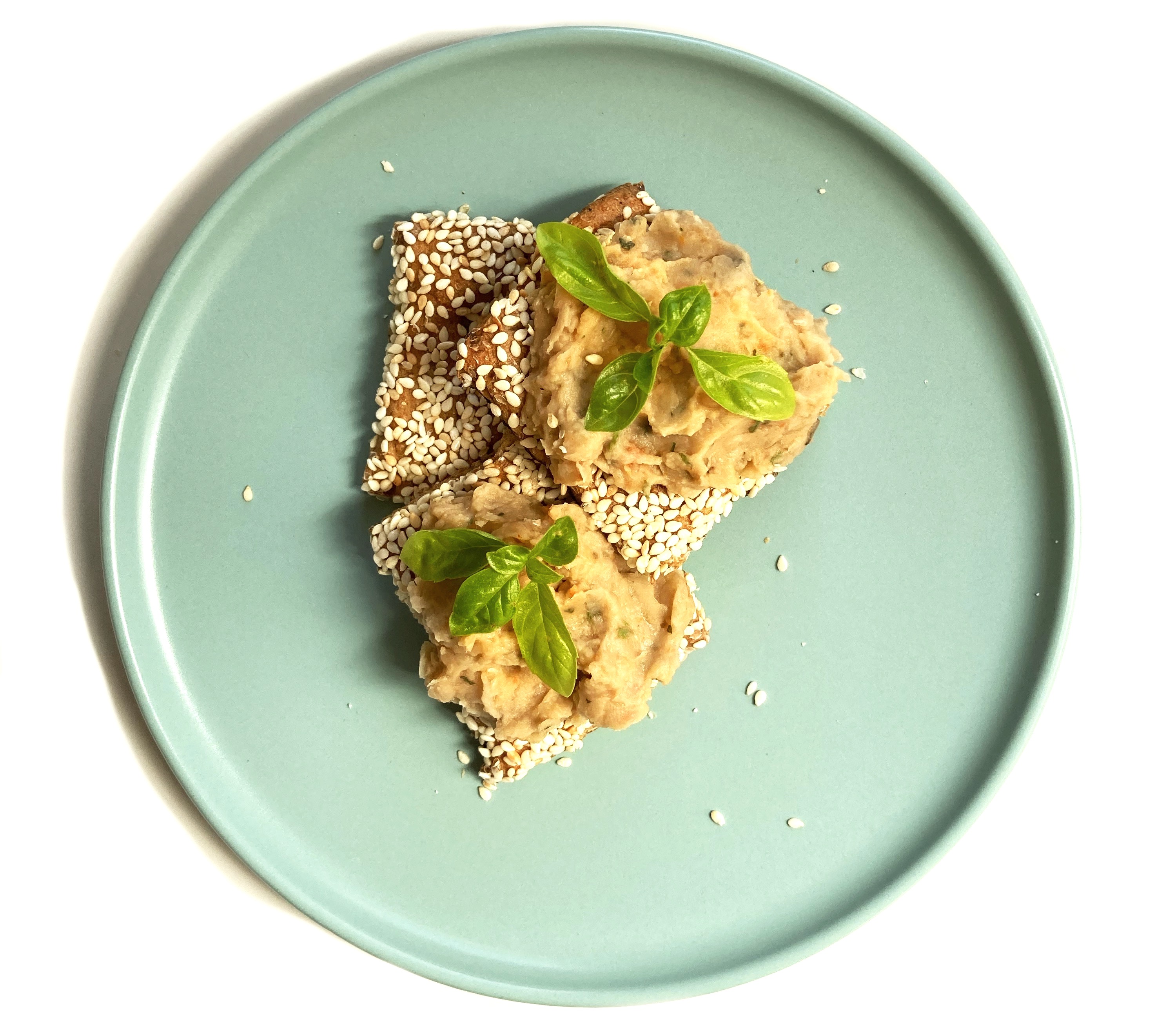 Sesame crackers topped with our homemade hummus