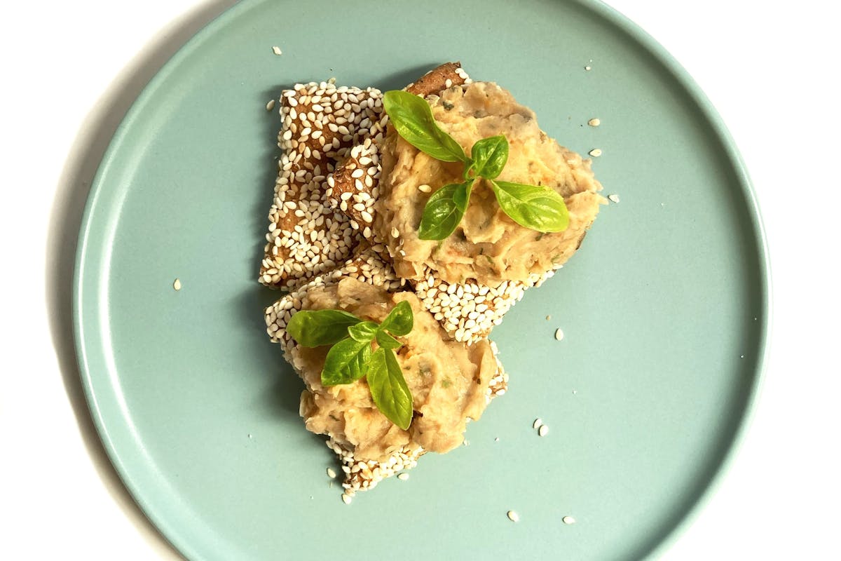 Sesame crackers topped with homemade hummus