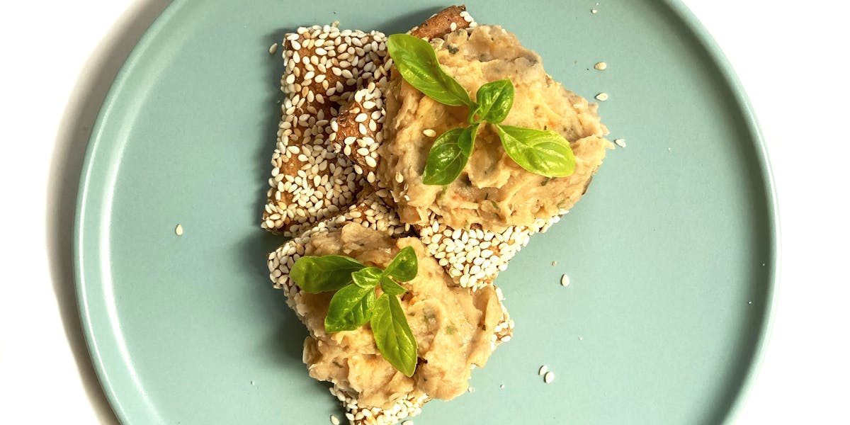 Sesame crackers topped with our homemade hummus