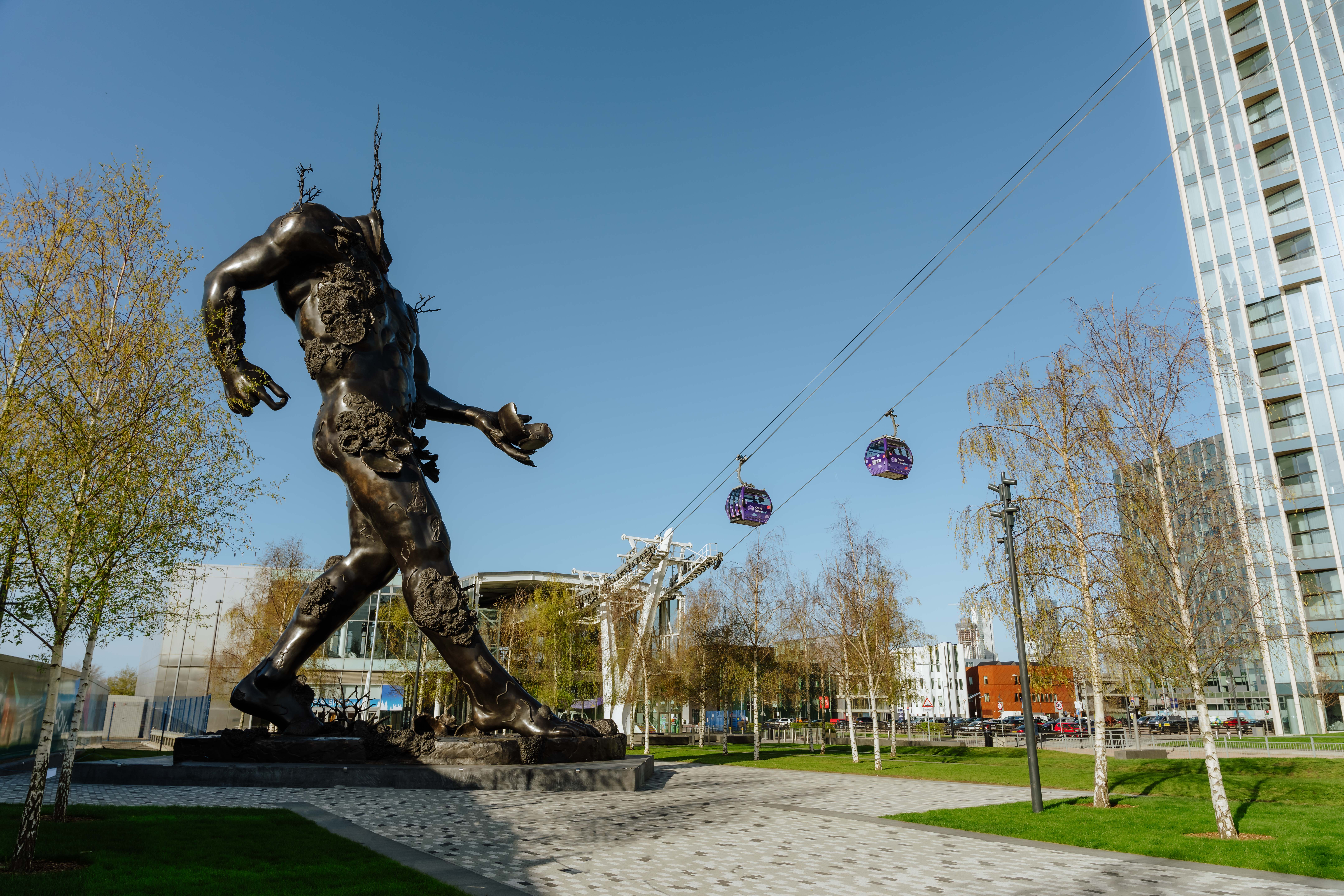 Demon with bowl sculpture with cable cars in the background