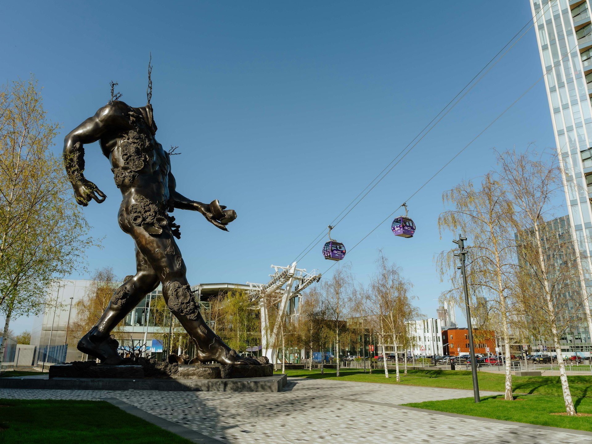 Demon with bowl sculpture with cable cars in the background