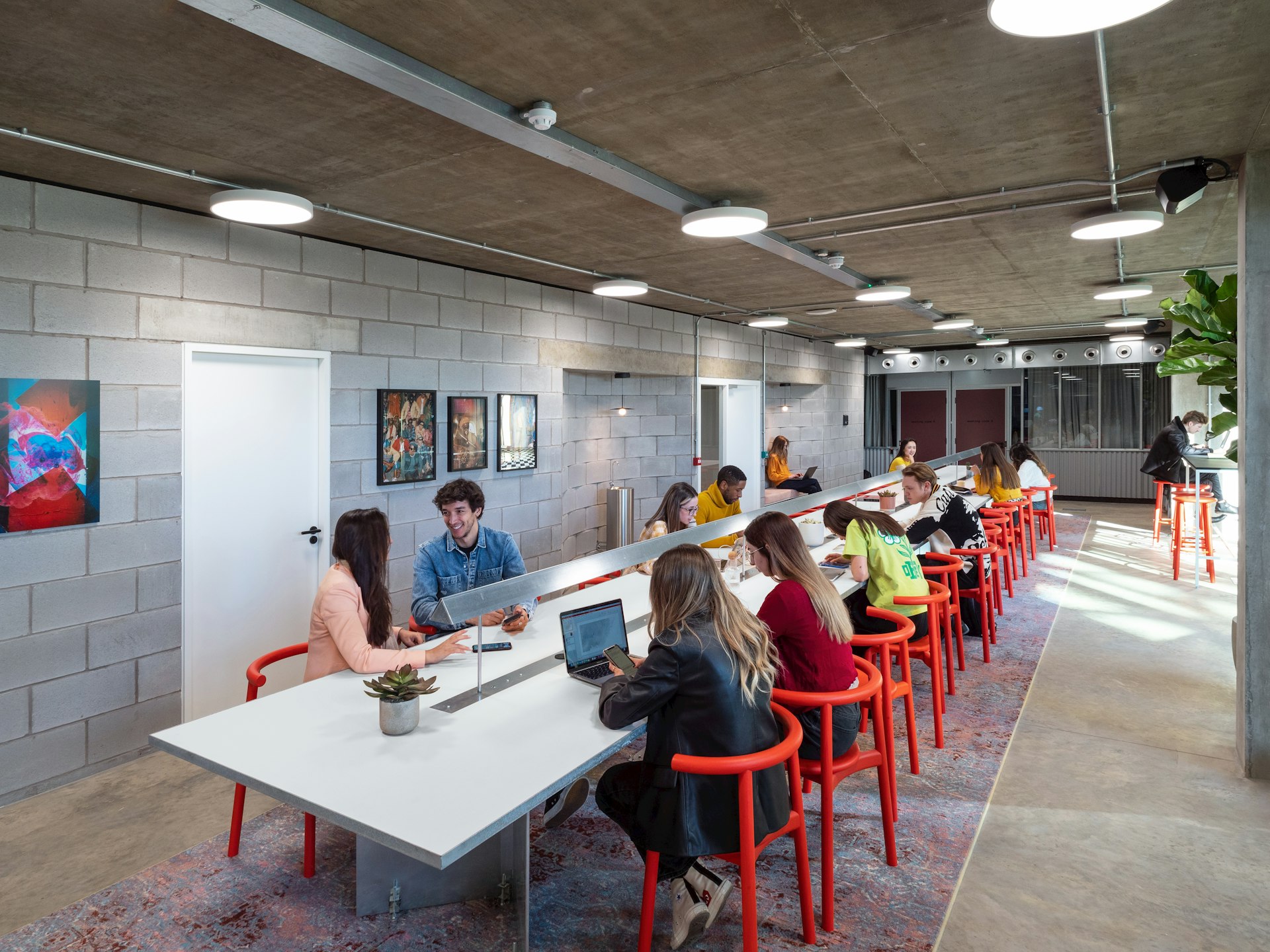 People communally working and socialising inside the Bureau