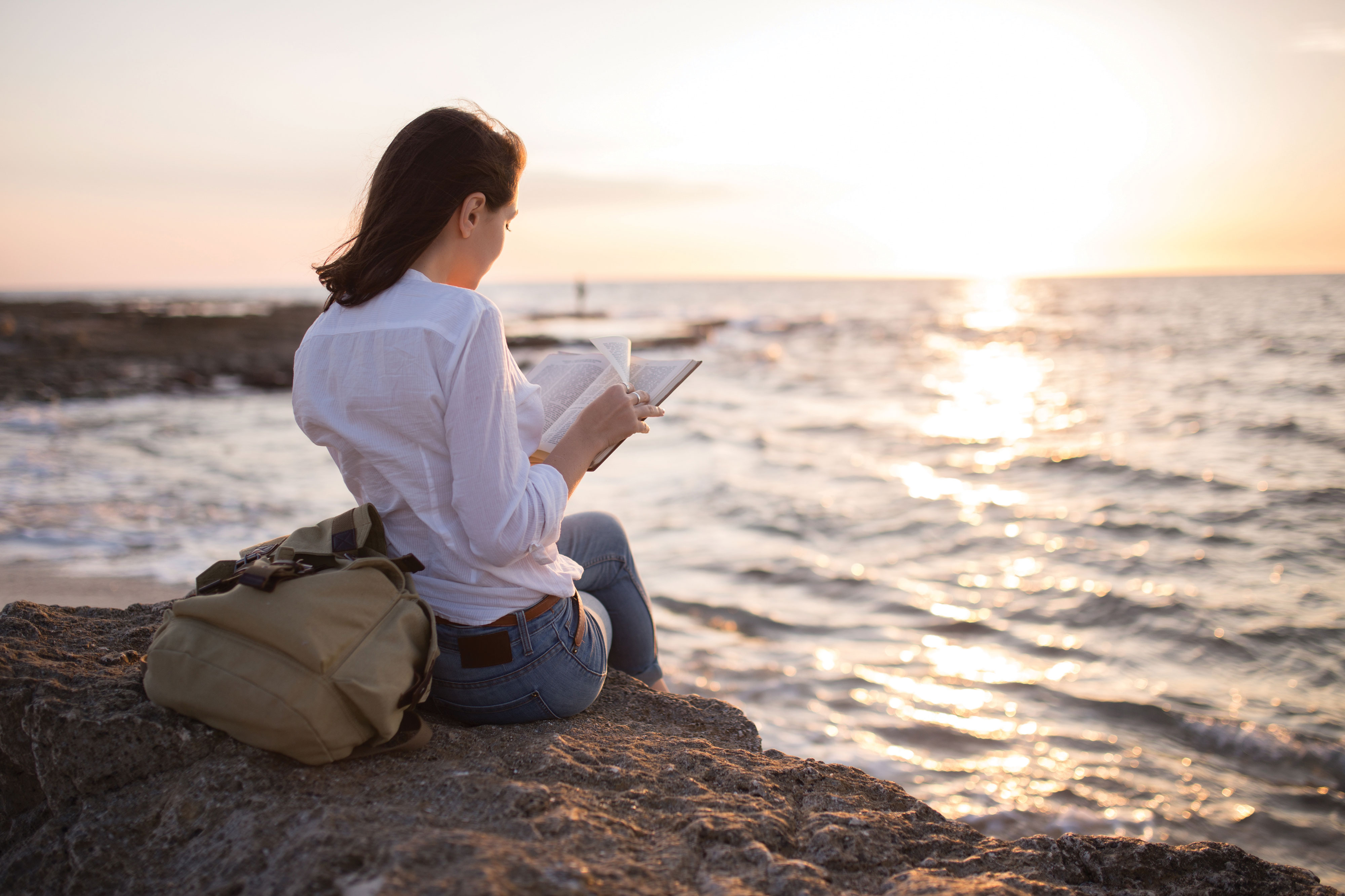woman reading on beach