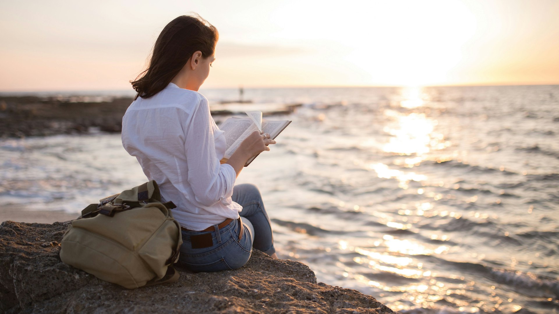 woman reading on beach