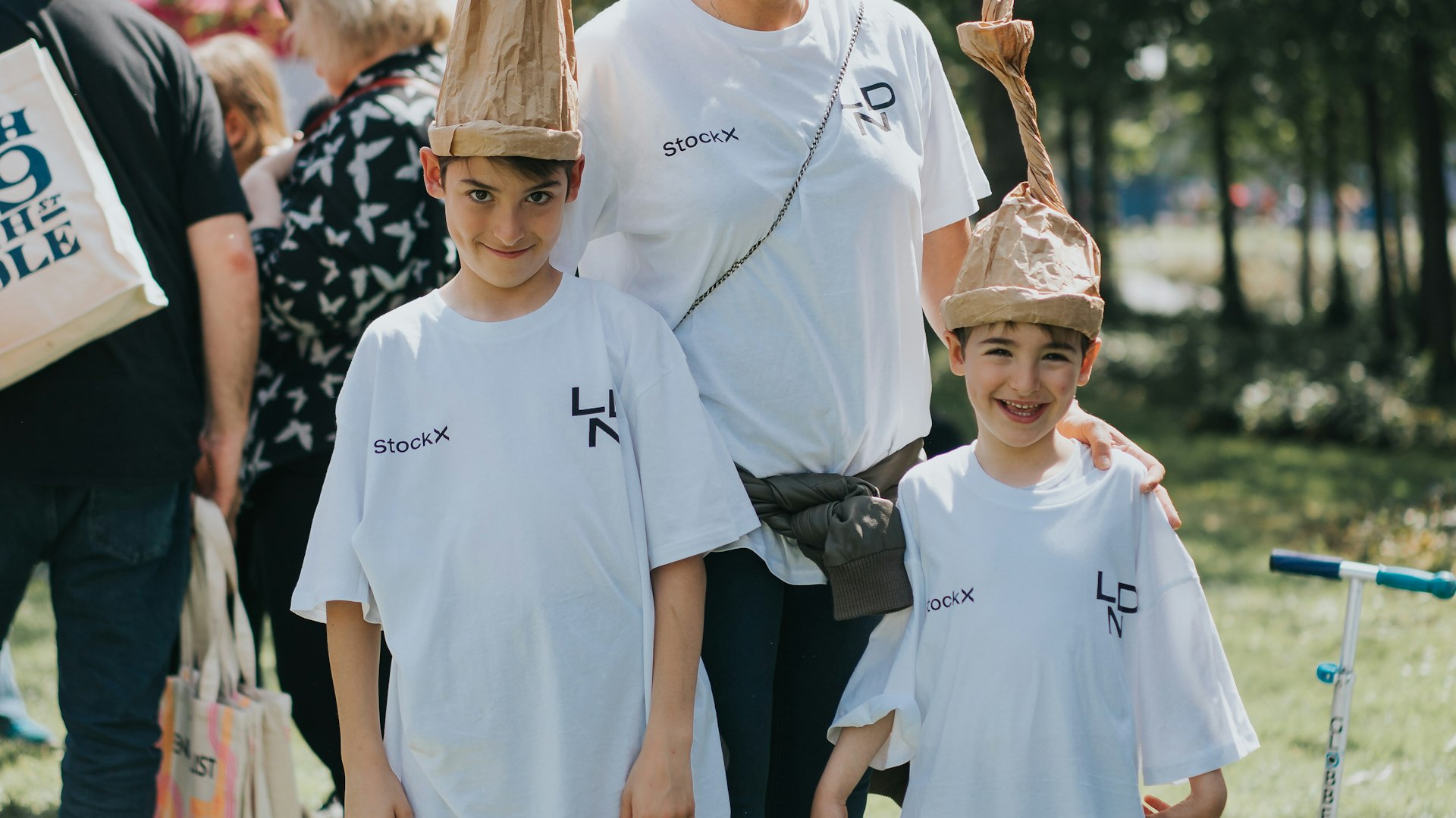 Two children pose with their hats