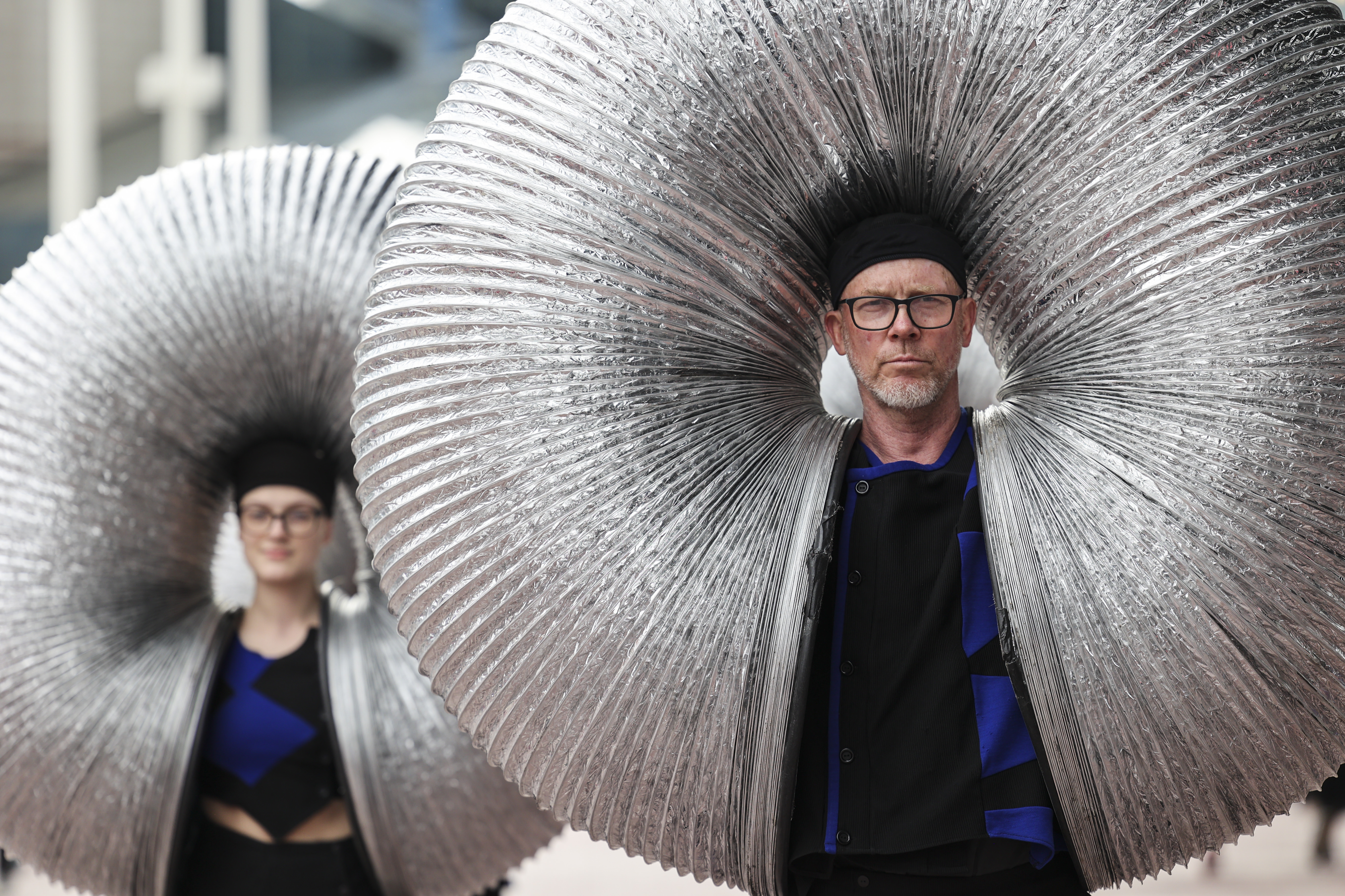 Two people wearing hats are inside some slinky springs