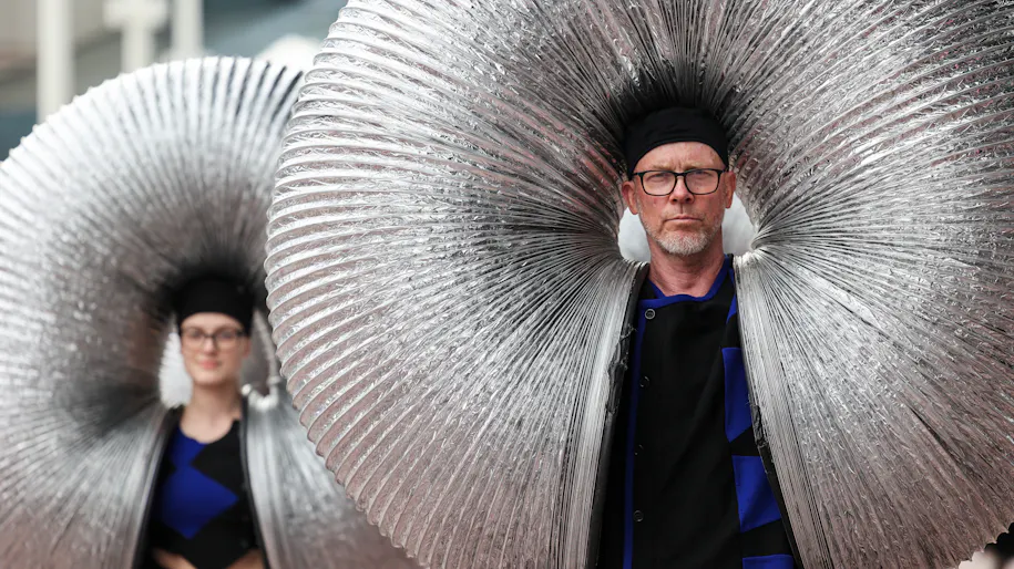 Two people wearing hats are inside some slinky springs