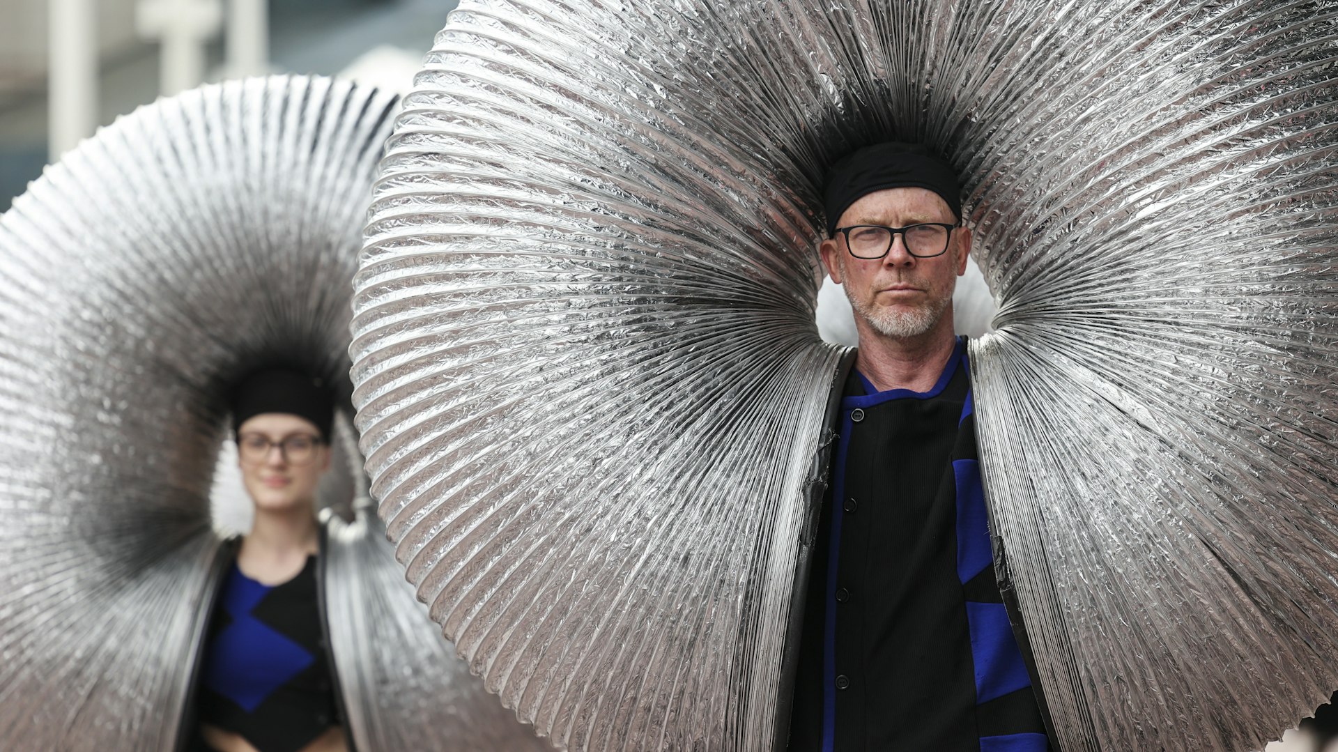 Two people wearing hats are inside some slinky springs