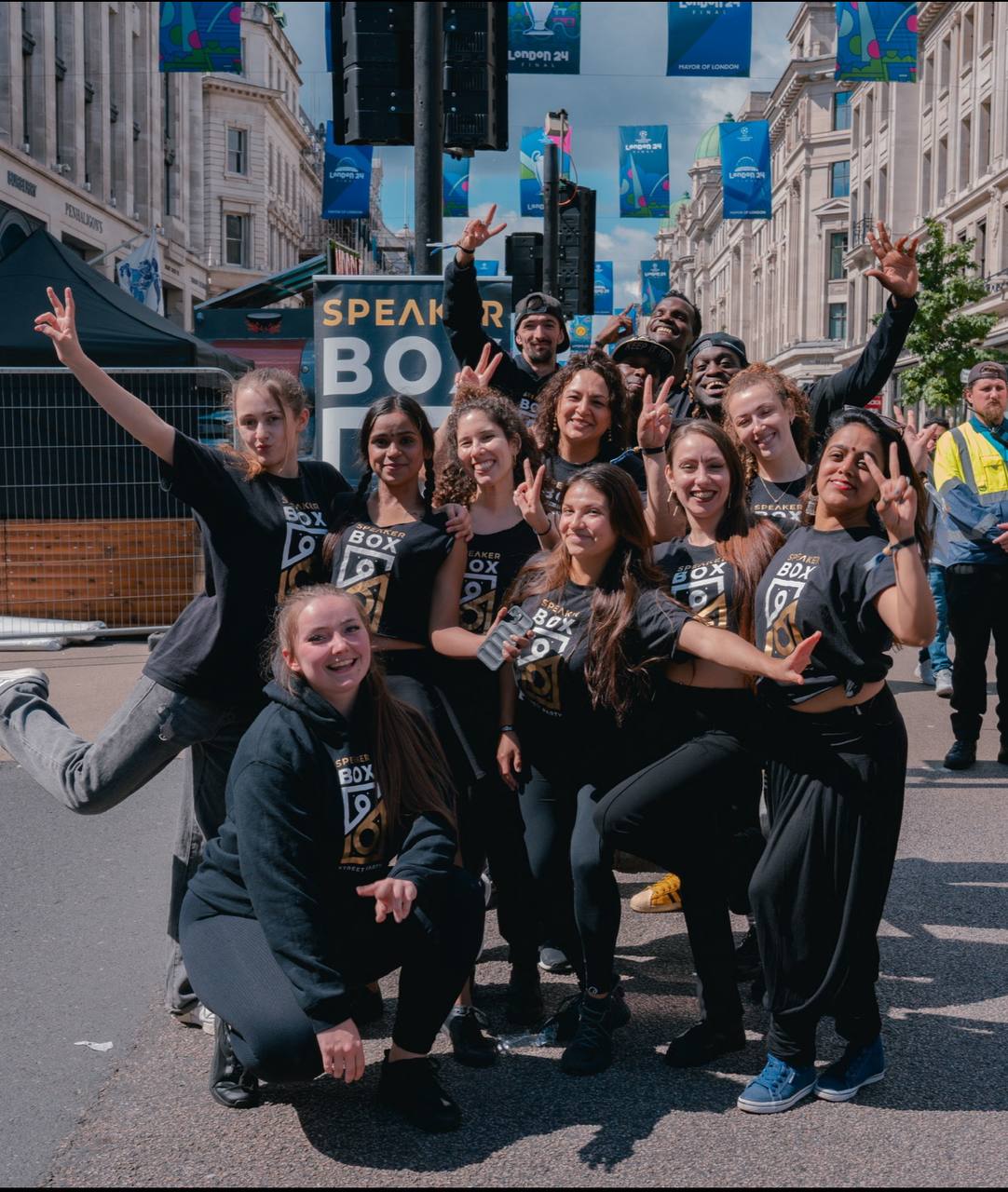 A large of dancers pose for the camera