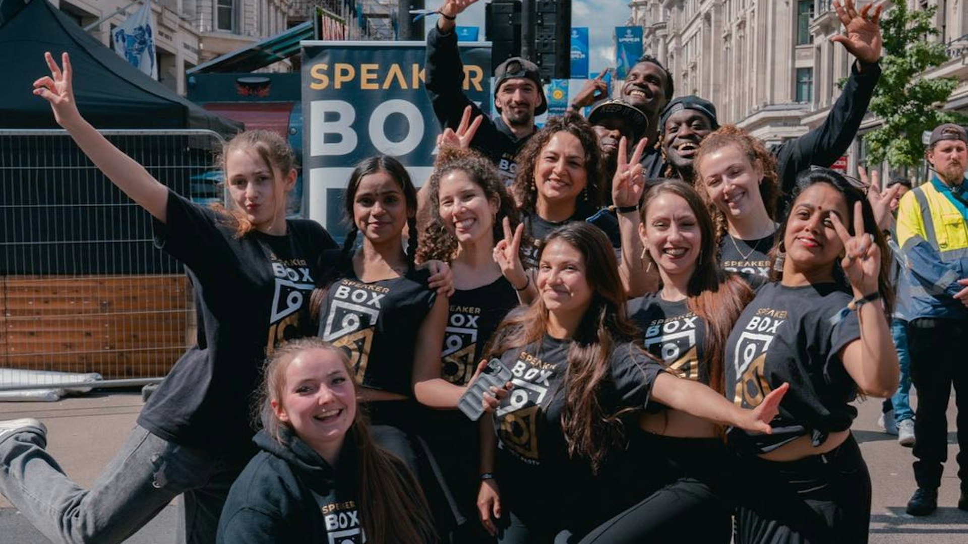 A large of dancers pose for the camera
