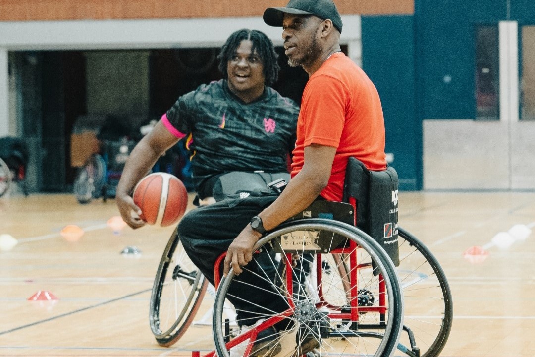 Two men play basketball