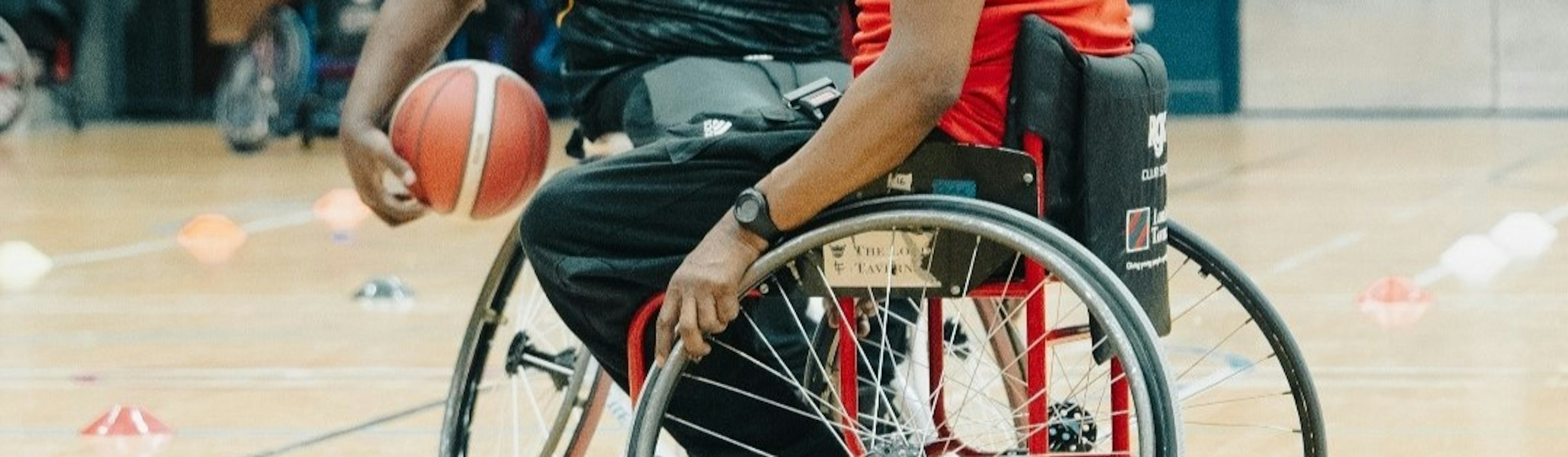 Two men play basketball