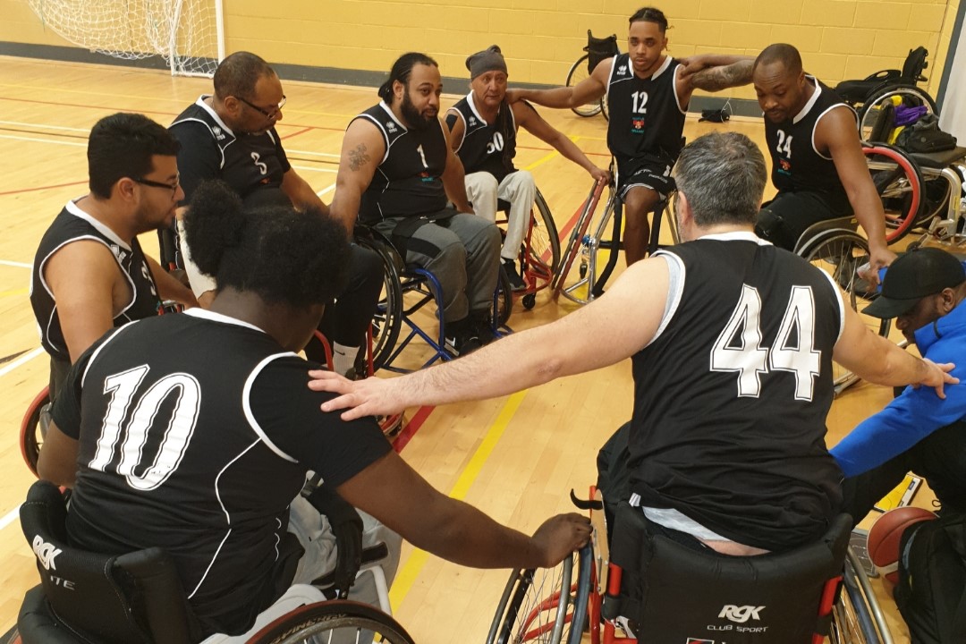 A team of basketball players huddle