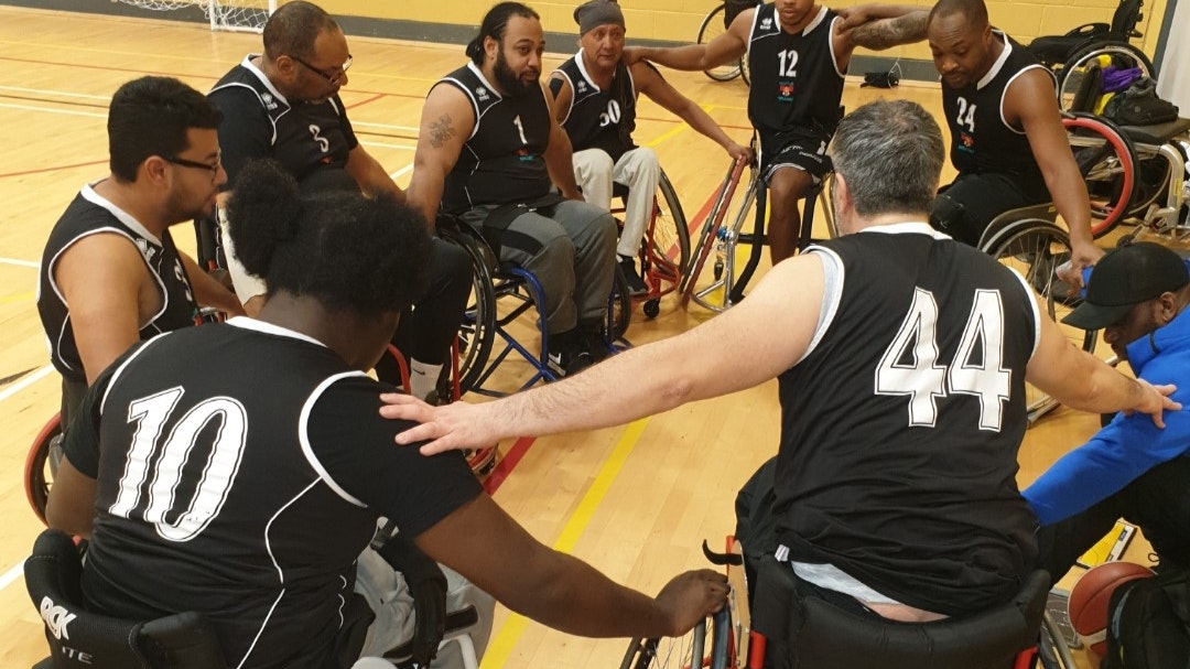 A team of basketball players huddle