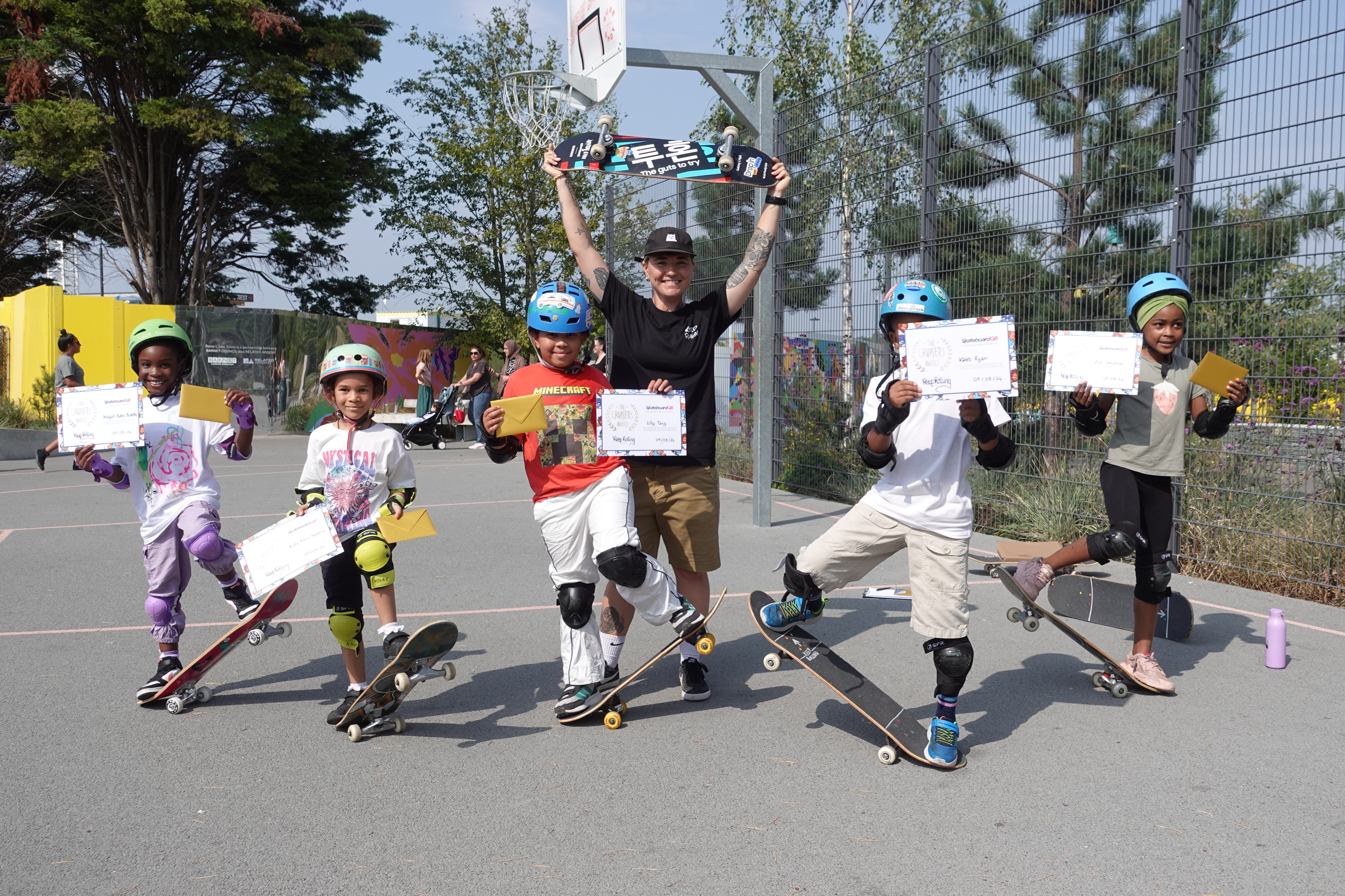 Children show their skateboarding certificates