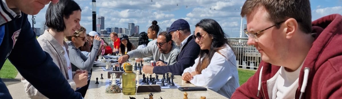 People playing chess in the sun