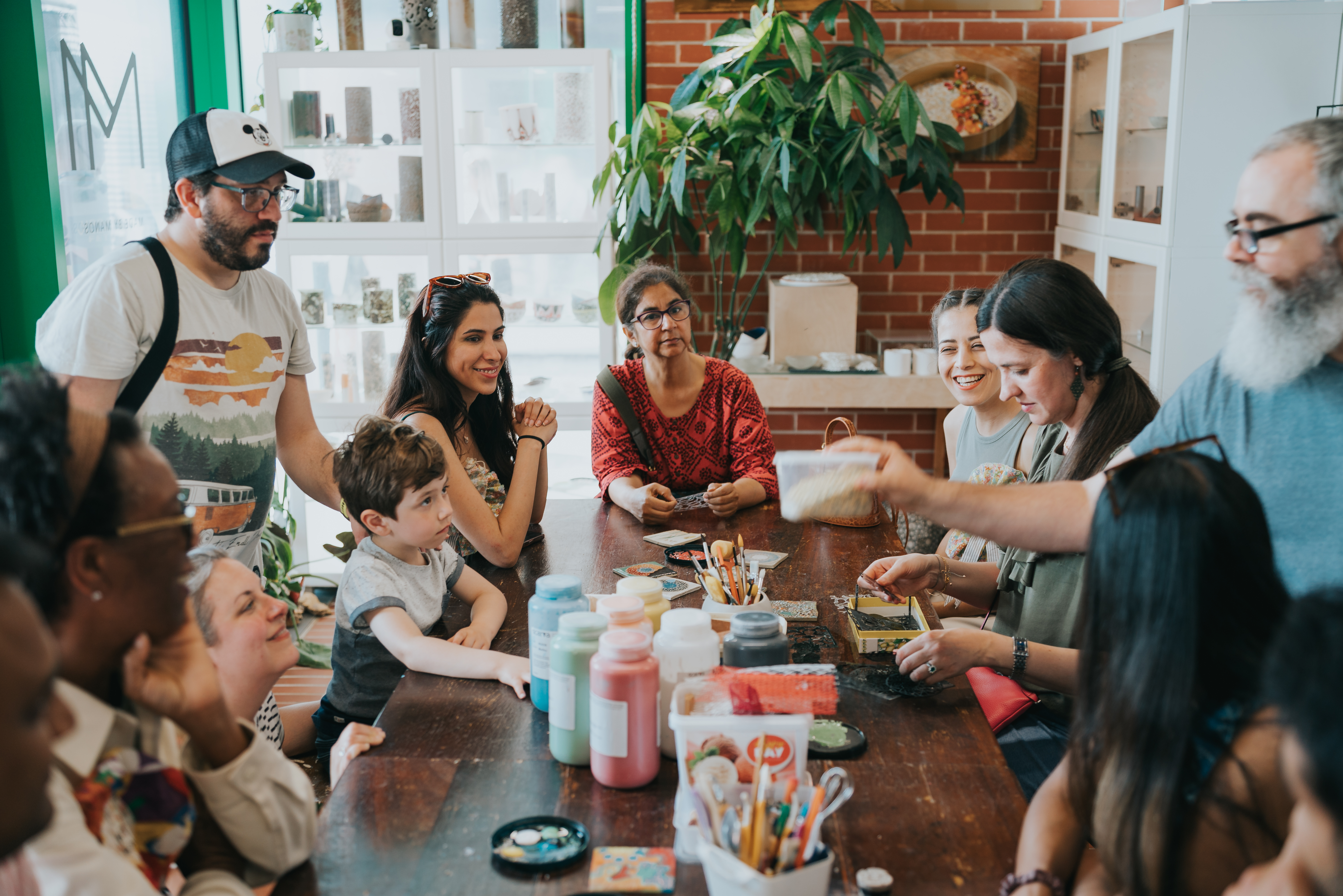 People sit around a table doing crafts