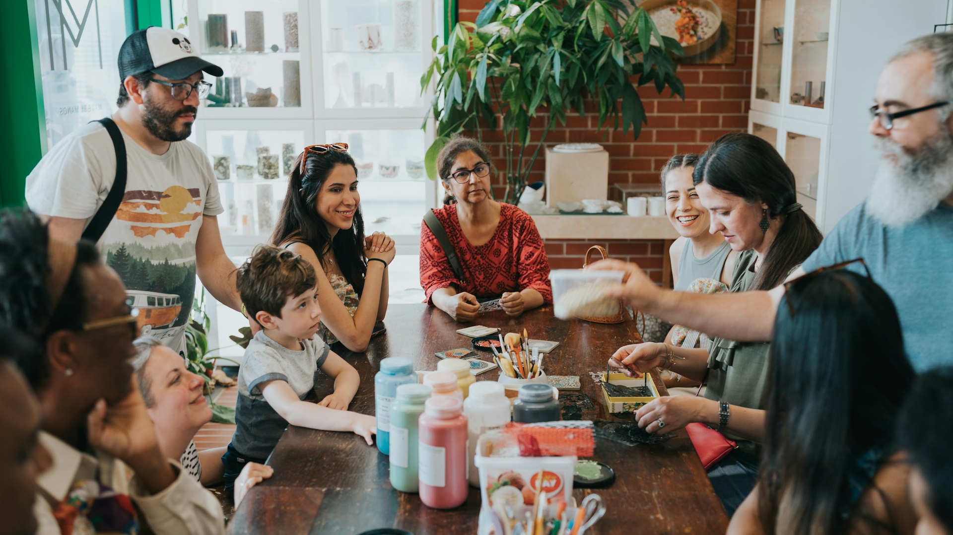 People sit around a table doing crafts