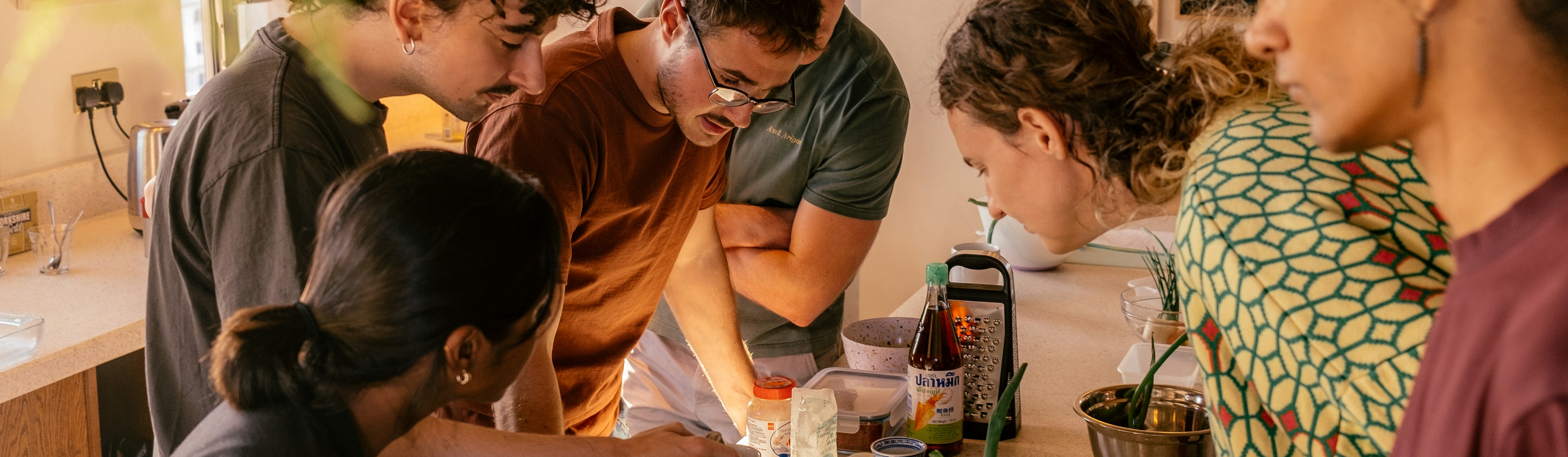 People in a kitchen making kimchi