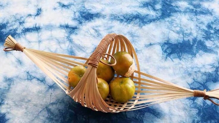 A bamboo basket with some fruit inside