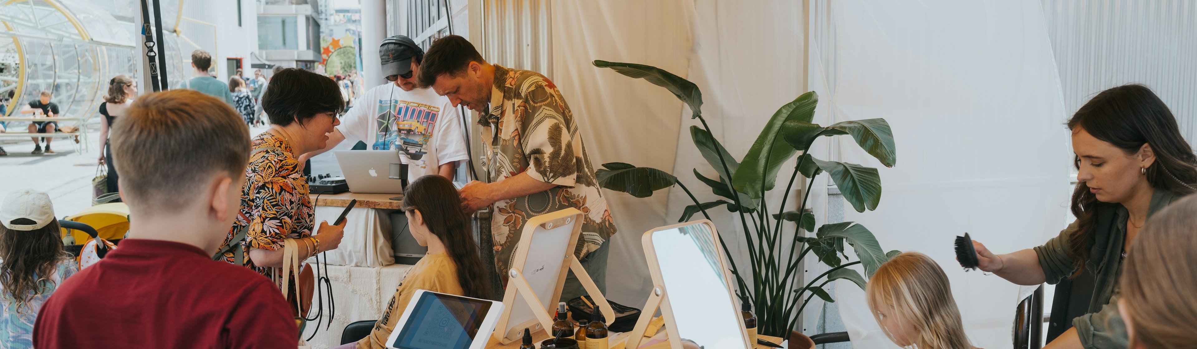 Kids getting braids in their hair at the stall